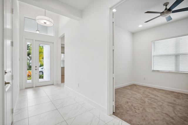 foyer with light carpet and ceiling fan