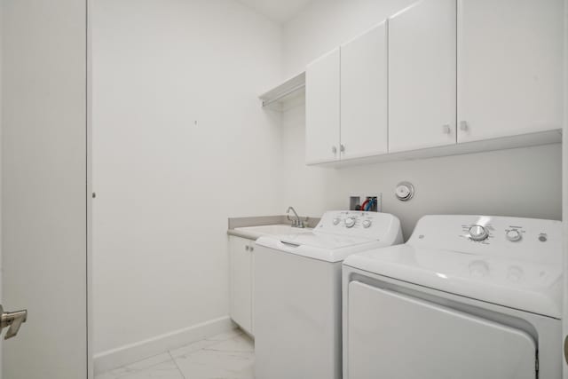 laundry area with cabinets, sink, and separate washer and dryer