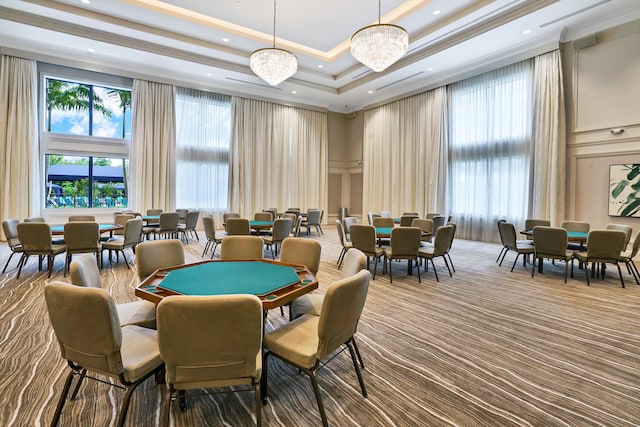 playroom featuring ornamental molding, carpet flooring, a raised ceiling, and a notable chandelier