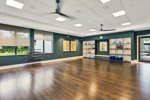 workout area with ceiling fan, plenty of natural light, and hardwood / wood-style floors