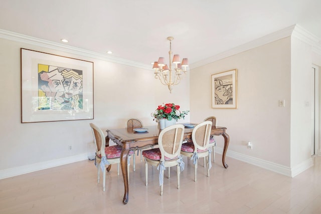 dining room with light hardwood / wood-style flooring, crown molding, and a notable chandelier