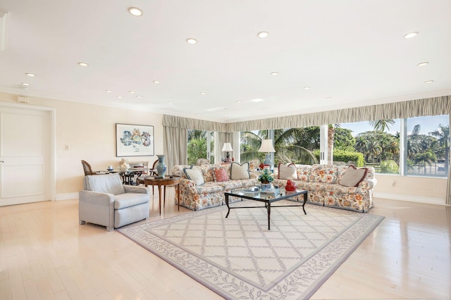 living room featuring light wood-type flooring and crown molding