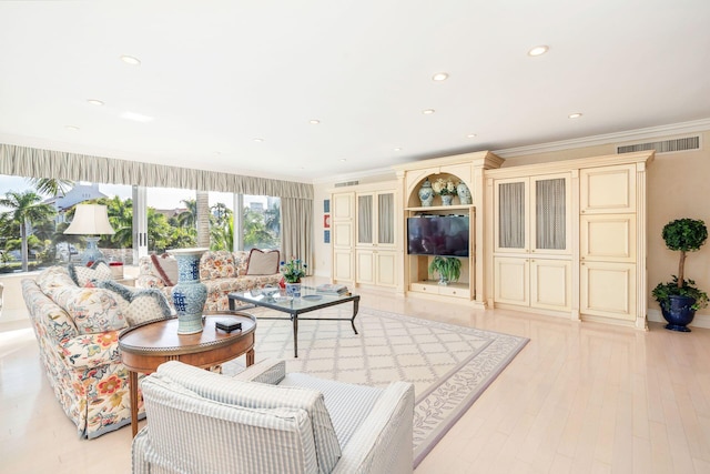 living room featuring light hardwood / wood-style flooring and crown molding