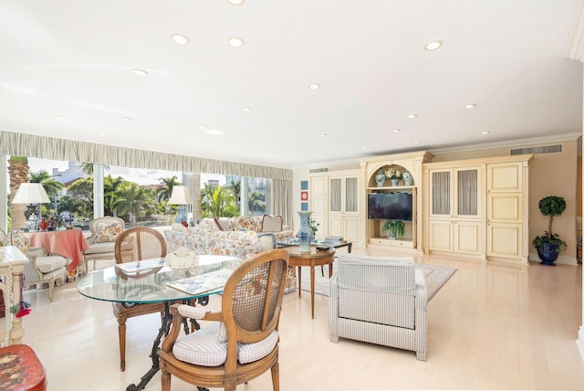 living room with light wood-type flooring and crown molding