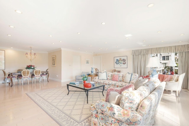 living room featuring light hardwood / wood-style flooring, crown molding, and an inviting chandelier