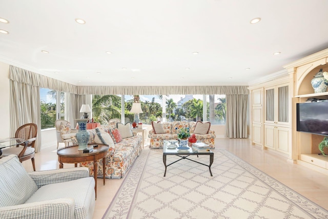 living room with light hardwood / wood-style floors, a wealth of natural light, and ornamental molding