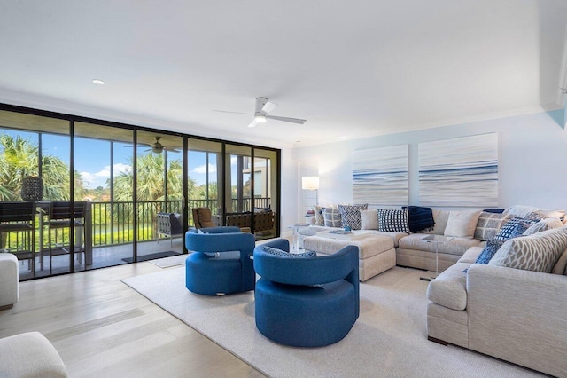 living room with ornamental molding, floor to ceiling windows, ceiling fan, and light hardwood / wood-style flooring