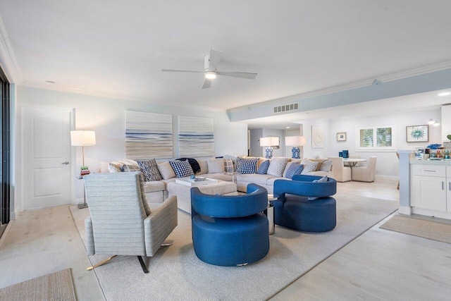 living room with light hardwood / wood-style flooring, ceiling fan, and crown molding