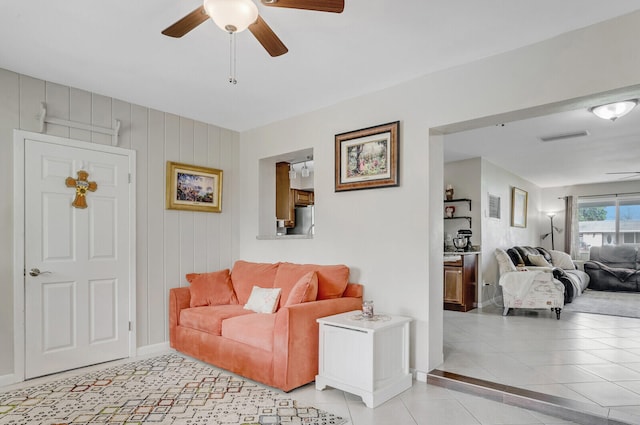 living room with ceiling fan and light tile patterned floors