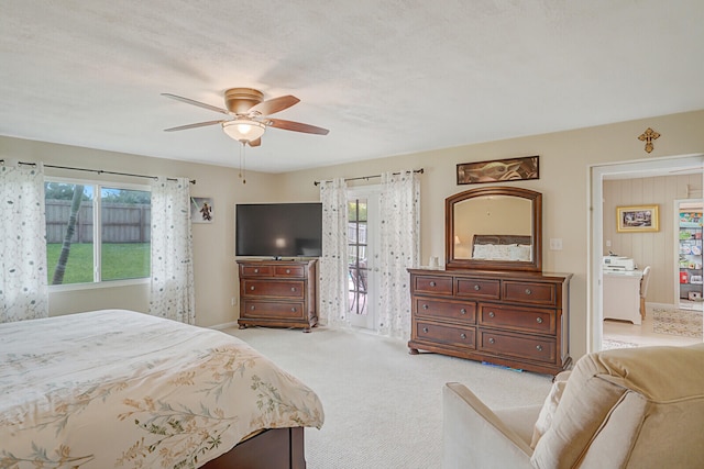 carpeted bedroom with ceiling fan, a textured ceiling, access to outside, and multiple windows