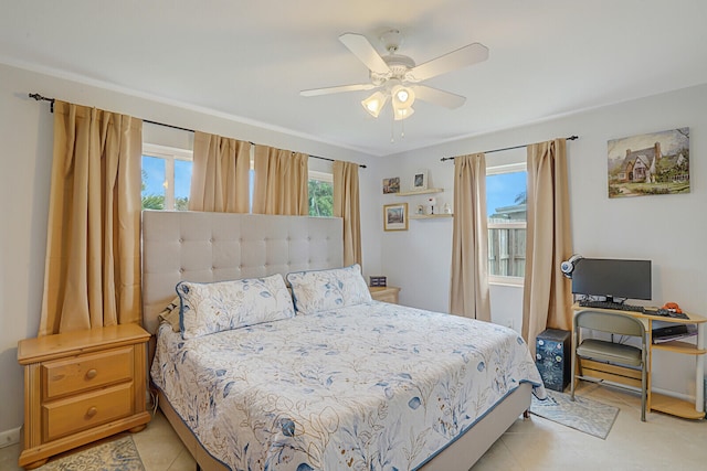 bedroom with ceiling fan, light tile patterned floors, and multiple windows