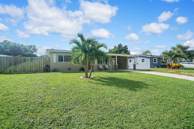 view of front of home with a carport and a front yard