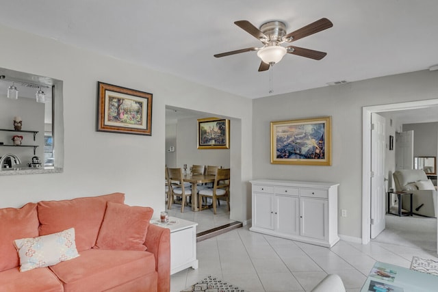 tiled living room featuring ceiling fan