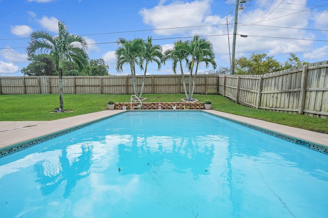 view of pool with a yard