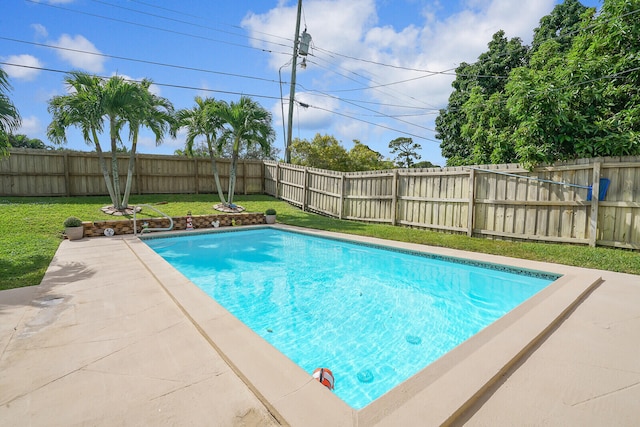 view of swimming pool with a lawn and a patio