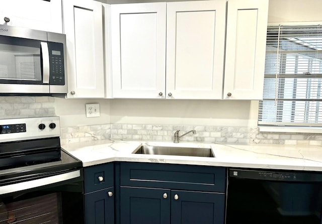 kitchen featuring white cabinets, stainless steel appliances, and sink