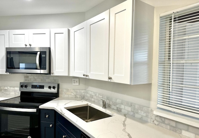 kitchen featuring white cabinetry, appliances with stainless steel finishes, and sink