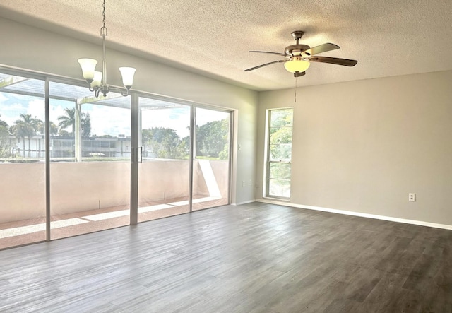 empty room with a textured ceiling, hardwood / wood-style floors, and ceiling fan with notable chandelier