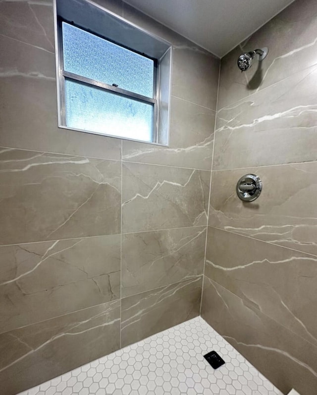 bathroom with tiled shower