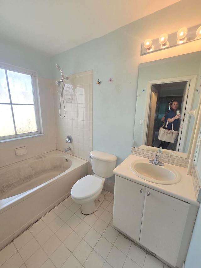 full bathroom with vanity, tile patterned floors, tiled shower / bath, and toilet