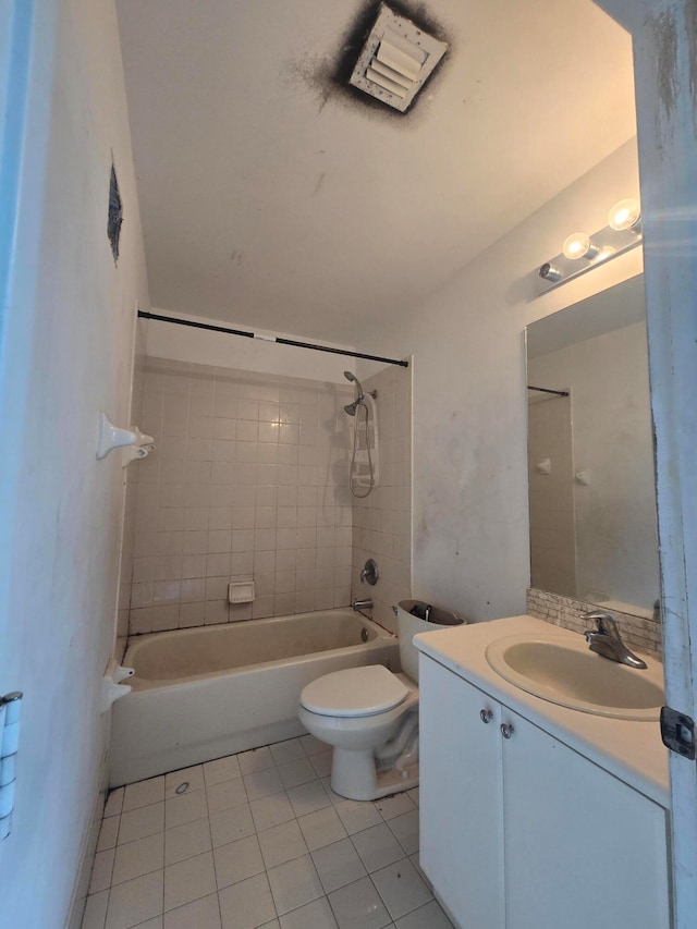 full bathroom featuring vanity, tile patterned flooring, toilet, and tiled shower / bath combo