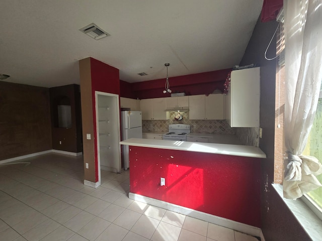 kitchen with white cabinets, white appliances, kitchen peninsula, and tasteful backsplash