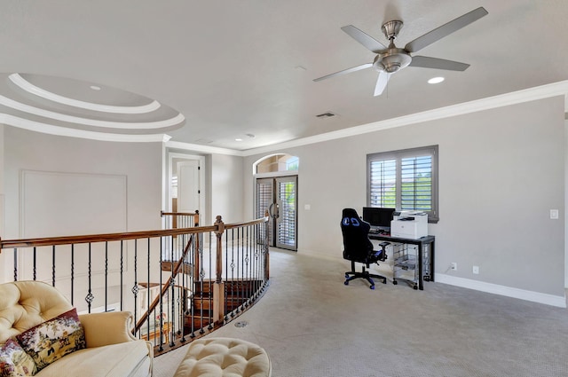 home office featuring light colored carpet, ceiling fan, ornamental molding, and a tray ceiling