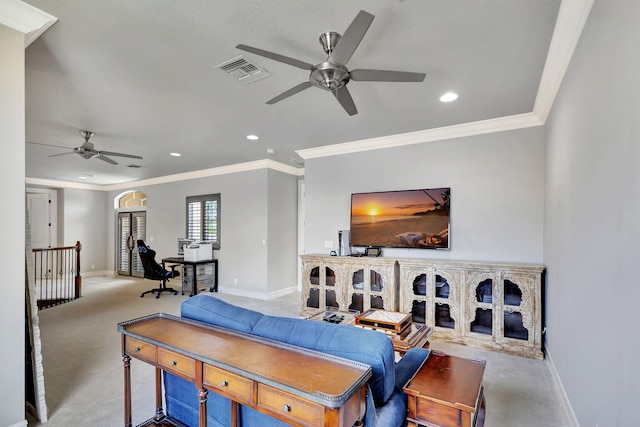 carpeted living room with ceiling fan and ornamental molding