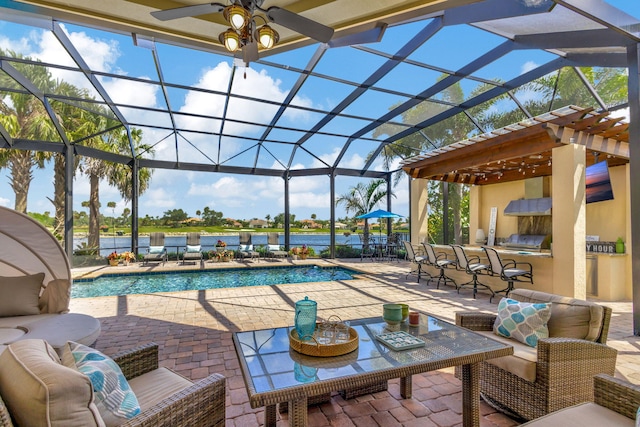 view of pool with a bar, an outdoor kitchen, a patio area, a lanai, and an outdoor hangout area