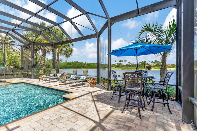 view of pool featuring a lanai, a water view, and a patio area