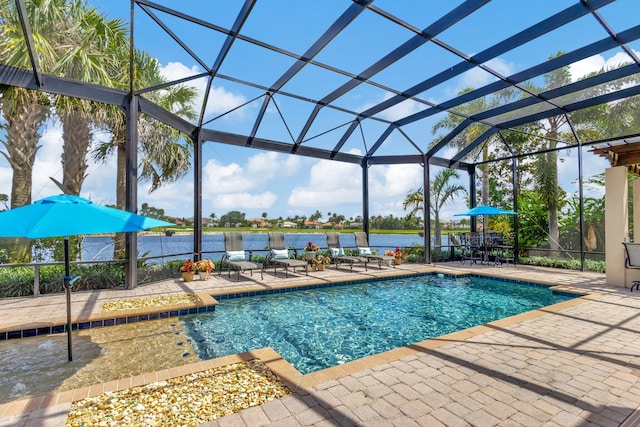 view of swimming pool featuring glass enclosure, a patio area, and a water view