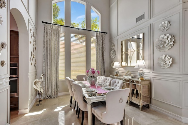 dining space with a towering ceiling