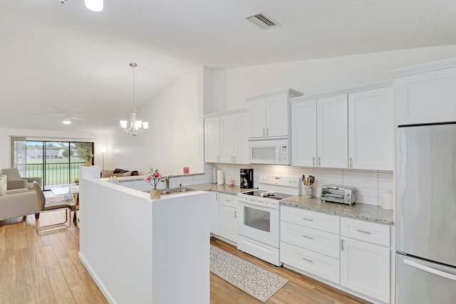 kitchen featuring tasteful backsplash, white cabinetry, vaulted ceiling, light hardwood / wood-style floors, and white appliances