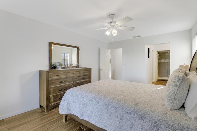 bedroom with baseboards, visible vents, ceiling fan, and wood finished floors