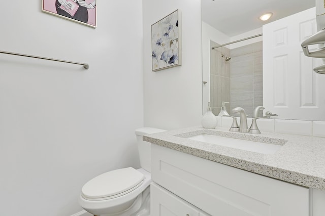 bathroom with vanity, toilet, and walk in shower