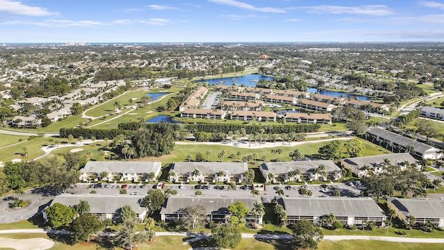 birds eye view of property featuring view of golf course, a water view, and a residential view