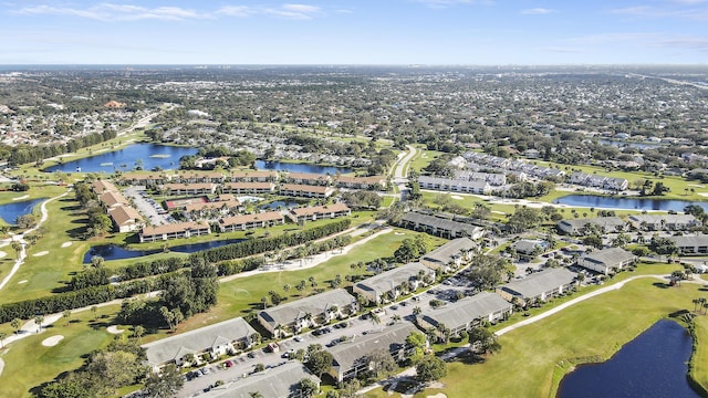 drone / aerial view with a water view and golf course view