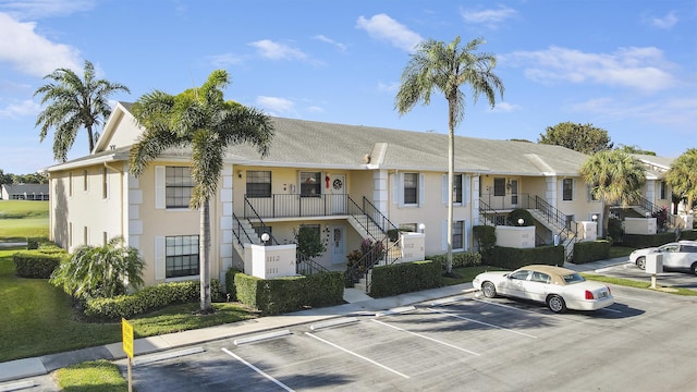 exterior space with uncovered parking, stairway, and a residential view