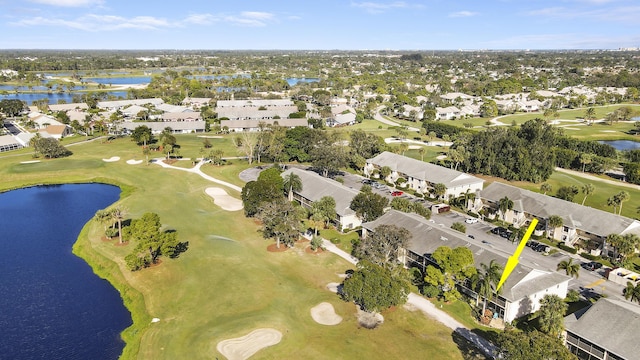 birds eye view of property with view of golf course, a water view, and a residential view