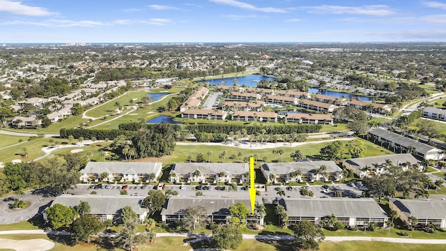 birds eye view of property featuring golf course view, a water view, and a residential view