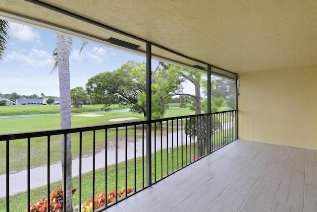 unfurnished sunroom featuring a wealth of natural light and golf course view