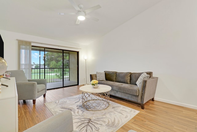 living room with ceiling fan and light hardwood / wood-style flooring