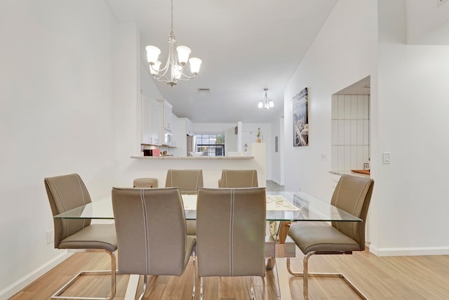 dining room featuring light hardwood / wood-style floors and an inviting chandelier