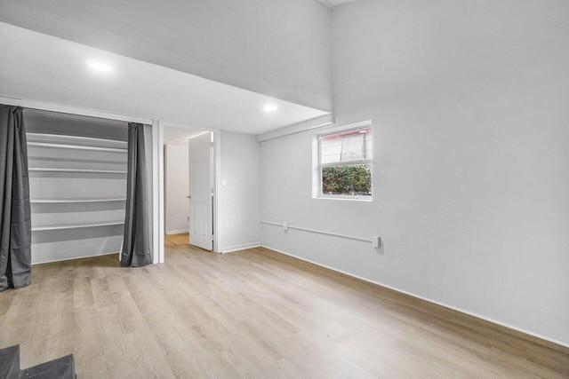 unfurnished bedroom featuring a closet and light hardwood / wood-style floors