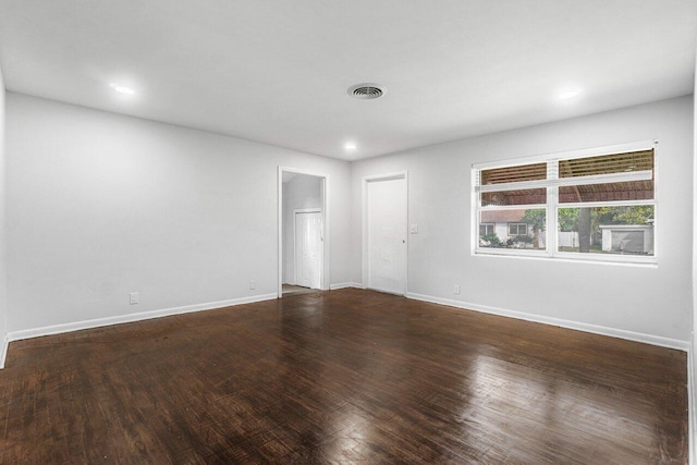 empty room with dark wood-type flooring