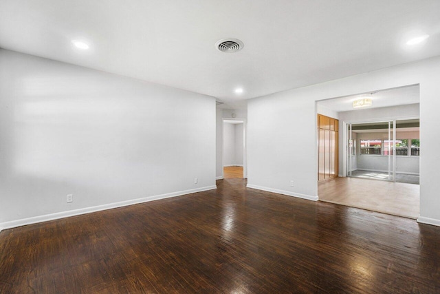 unfurnished room featuring dark wood-type flooring