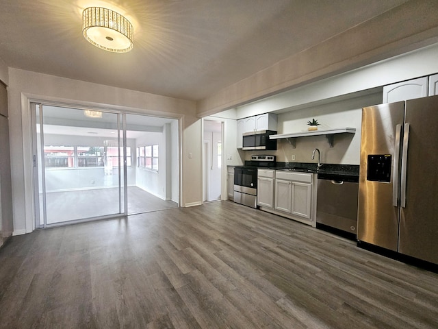 kitchen featuring white cabinetry, dark hardwood / wood-style flooring, sink, and appliances with stainless steel finishes