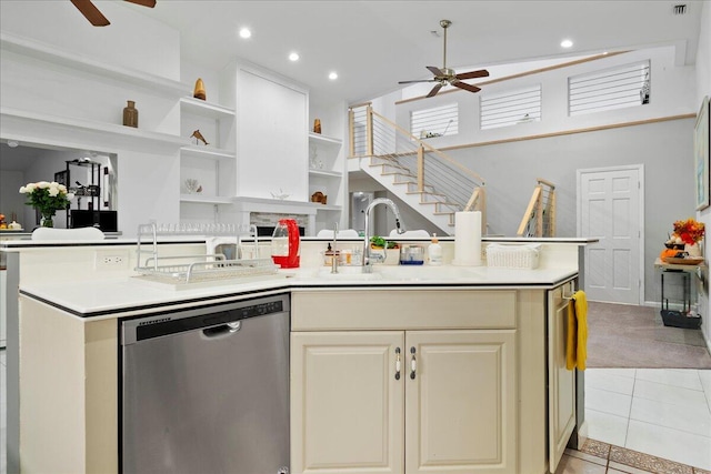 kitchen with a kitchen island with sink, sink, stainless steel dishwasher, ceiling fan, and light tile patterned floors