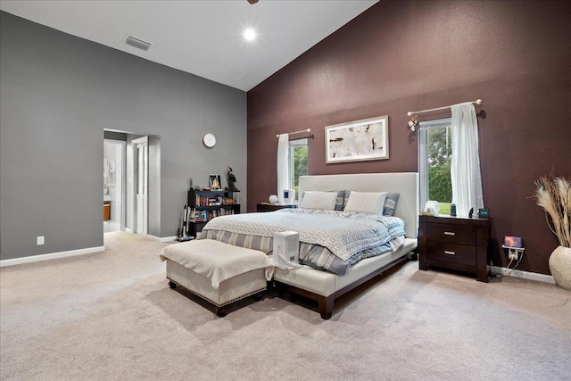 carpeted bedroom featuring high vaulted ceiling