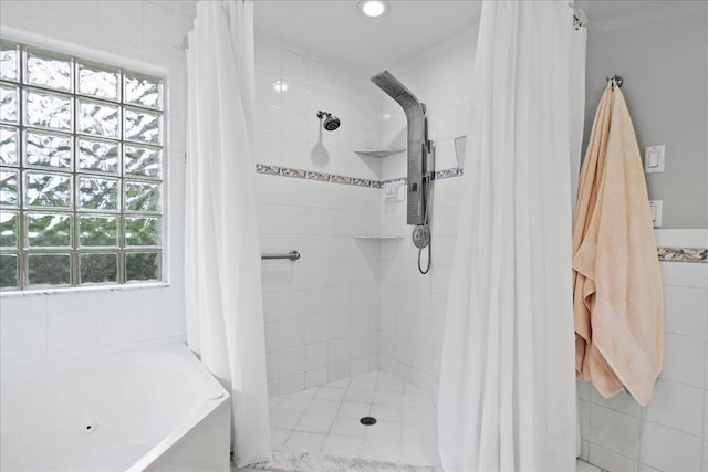 bathroom with plenty of natural light and independent shower and bath